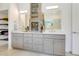 Modern bathroom features dual vanities, a glass-enclosed shower, and plenty of storage space at 1990 Wallingford Loop, Mount Dora, FL 32757