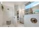Modern bathroom featuring a glass-enclosed shower, gray vanity, and sleek fixtures at 1990 Wallingford Loop, Mount Dora, FL 32757