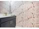 Stylish powder room showcasing flamingo wallpaper, vanity and gold fixtures at 1990 Wallingford Loop, Mount Dora, FL 32757
