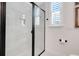 Modern bathroom featuring a glass shower with black trim and a bright window at 1990 Wallingford Loop, Mount Dora, FL 32757