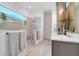 Sleek bathroom featuring glass-enclosed shower, modern fixtures, and elegant gray vanity for a spa-like feel at 1990 Wallingford Loop, Mount Dora, FL 32757