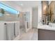 Modern bathroom featuring a walk-in shower, sleek fixtures, and a bright window at 1990 Wallingford Loop, Mount Dora, FL 32757