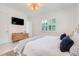 Bright bedroom features white shutters, soft bedding, and a modern dresser for a relaxed atmosphere at 1990 Wallingford Loop, Mount Dora, FL 32757