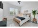 Cozy bedroom featuring modern decor, natural textures, and ample natural light at 1990 Wallingford Loop, Mount Dora, FL 32757