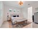 Cozy bedroom with floral headboard, comfortable bedding, accent pillows, and soft natural lighting at 1990 Wallingford Loop, Mount Dora, FL 32757