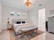 Airy bedroom featuring a floral headboard, stylish rug, and ample natural light at 1990 Wallingford Loop, Mount Dora, FL 32757