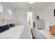 Inviting bedroom boasts soft bedding, a blue bench, and a view of a dressing area with mirror at 1990 Wallingford Loop, Mount Dora, FL 32757