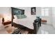 Elegant bedroom with a dark wood bed frame, stylish rug, and bright natural light at 1990 Wallingford Loop, Mount Dora, FL 32757