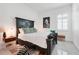 Cozy bedroom with an upholstered bench, zebra-print rug, and natural light at 1990 Wallingford Loop, Mount Dora, FL 32757