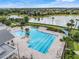Aerial view of the resort-style community pool with lounge chairs and tropical landscaping at 1990 Wallingford Loop, Mount Dora, FL 32757