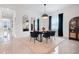 Bright dining area with elegant table and black chairs complemented by modern decor and ample natural light at 1990 Wallingford Loop, Mount Dora, FL 32757