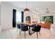 Bright dining area features modern chandelier, sleek table, and black chairs in an open floor plan at 1990 Wallingford Loop, Mount Dora, FL 32757
