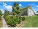 Beautiful backyard view with lush landscaping and screened patio with ceiling fan at 1990 Wallingford Loop, Mount Dora, FL 32757