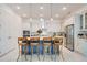 Bright kitchen features an island with counter seating, stainless steel appliances and updated cabinetry at 1990 Wallingford Loop, Mount Dora, FL 32757