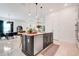 Open concept kitchen featuring a central island with stainless steel dishwasher, seating and dining area at 1990 Wallingford Loop, Mount Dora, FL 32757