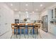 Modern kitchen with a blue island, white cabinets, stainless steel appliances, and bar stool seating at 1990 Wallingford Loop, Mount Dora, FL 32757