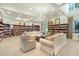 Well-stocked library with comfortable seating and a chandelier at 1990 Wallingford Loop, Mount Dora, FL 32757