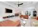 Spacious living room featuring stylish furniture, modern lighting, and an open layout to kitchen at 1990 Wallingford Loop, Mount Dora, FL 32757