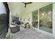Covered outdoor patio featuring comfortable seating and a view of the backyard at 1990 Wallingford Loop, Mount Dora, FL 32757