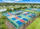 Aerial view of pickleball courts in a residential community with lush landscaping at 1990 Wallingford Loop, Mount Dora, FL 32757