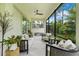 Inviting screened porch with plush seating, ceiling fan, and peaceful backyard views at 1990 Wallingford Loop, Mount Dora, FL 32757