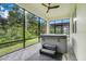 Tranquil screened-in porch featuring a relaxing hot tub and view of nature at 1990 Wallingford Loop, Mount Dora, FL 32757