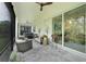 Spacious screened-in porch with comfortable seating, hot tub, and outdoor ceiling fans at 1990 Wallingford Loop, Mount Dora, FL 32757