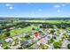 Wide aerial shot of a residential area next to a golf course, highlighting the neighborhood's layout at 2017 Palo Alto Ave, The Villages, FL 32159