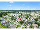 Stunning aerial view of a neighborhood featuring houses nestled around a scenic lake and golf course at 2017 Palo Alto Ave, The Villages, FL 32159