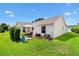 Home exterior showcasing a well-maintained yard and patio area for outdoor enjoyment at 2017 Palo Alto Ave, The Villages, FL 32159