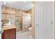 Bathroom with a walk-in shower, tiled walls, and a wooden vanity at 2017 Palo Alto Ave, The Villages, FL 32159
