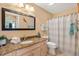 Bright bathroom featuring granite counters, tiled floors, and nautical decor at 2017 Palo Alto Ave, The Villages, FL 32159