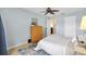 Bedroom featuring a woven dresser, ceiling fan and neutral-toned walls at 2017 Palo Alto Ave, The Villages, FL 32159