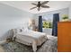 Cozy bedroom with a ceiling fan, large window, and relaxing blue accents at 2017 Palo Alto Ave, The Villages, FL 32159