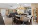 Open concept dining area with tile floors and a wooden table is adjacent to the kitchen and living room at 2017 Palo Alto Ave, The Villages, FL 32159
