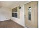 Inviting front entrance featuring a decorative glass door, neutral color palette, and charming details at 2017 Palo Alto Ave, The Villages, FL 32159