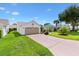 Charming single Gathering home with well manicured landscaping, mature trees and an attached two car garage at 2017 Palo Alto Ave, The Villages, FL 32159