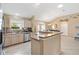 Open kitchen featuring stainless steel appliances and light wood cabinets, flowing into the dining area at 2017 Palo Alto Ave, The Villages, FL 32159