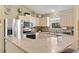 Inviting kitchen with stainless steel appliances, light wood cabinets, and a breakfast bar at 2017 Palo Alto Ave, The Villages, FL 32159