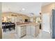 Open kitchen with a breakfast bar flowing into the dining area and living room at 2017 Palo Alto Ave, The Villages, FL 32159