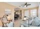 Comfortable living room with tile floors, ceiling fan, and connection to other rooms at 2017 Palo Alto Ave, The Villages, FL 32159