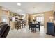 Open-concept living and dining area with a kitchen featuring stainless steel appliances and a breakfast bar at 2017 Palo Alto Ave, The Villages, FL 32159