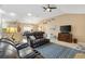 Comfortable living room featuring a vaulted ceiling, neutral colors, and an abundance of natural light at 2017 Palo Alto Ave, The Villages, FL 32159
