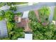 An aerial view of the home showcasing mature trees and a manicured landscape at 212 Blossom Ln, Winter Park, FL 32789