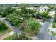 An aerial view of a house in a tree-lined neighborhood with a wide street at 212 Blossom Ln, Winter Park, FL 32789