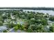An aerial view of a home in a leafy neighborhood near a lake and the city skyline at 212 Blossom Ln, Winter Park, FL 32789