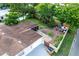 A landscaped backyard featuring a stone firepit, outdoor dining area, and partial privacy fence at 212 Blossom Ln, Winter Park, FL 32789