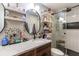 Bathroom showcasing granite counters, dual sinks, and a modern glass-enclosed shower at 212 Blossom Ln, Winter Park, FL 32789