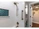 Updated shower boasts white subway tile, a teal accent niche, and bronze fixtures at 212 Blossom Ln, Winter Park, FL 32789