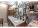 Bathroom featuring double sink vanity, with granite countertop and stylish round mirrors at 212 Blossom Ln, Winter Park, FL 32789